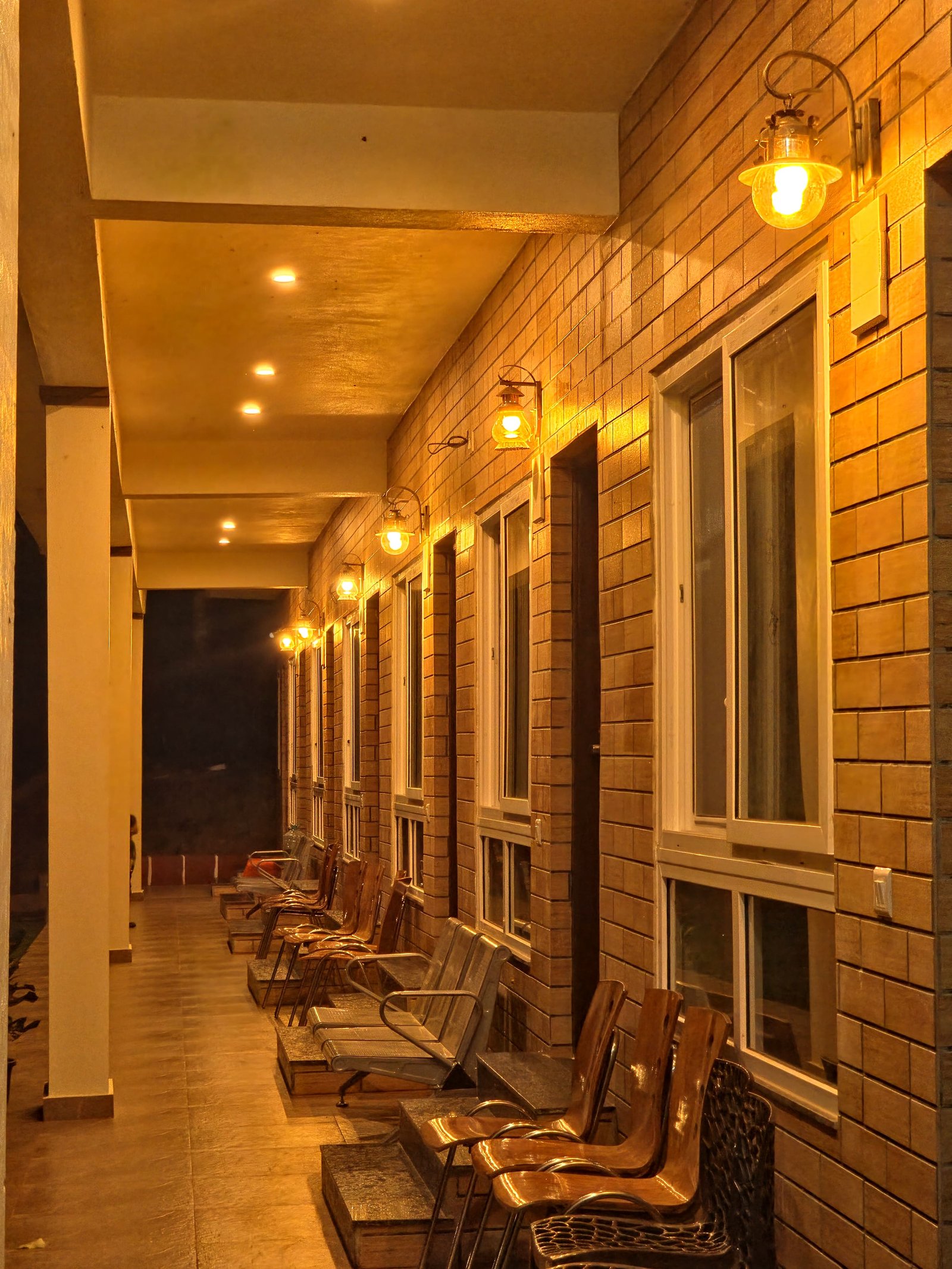 Lamp-lit garden path beside the rooms